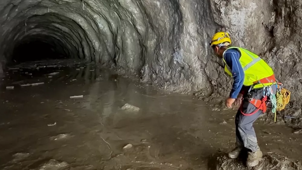 A rescuer works at the entrance of a tunnel at Chilime Hydropower Plant as rescue operations continue for people trapped inside following deadly flash floods and a mudslide, in Rasuwa, Nepal, August 29, 2026, in this screengrab obtained from a social media video. Ashish Gurung/via REUTERS THIS IMAGE HAS BEEN SUPPLIED BY A THIRD PARTY. MANDATORY CREDIT. NO RESALES. NO ARCHIVES. THIS PICTURE WAS CROPPED BY REUTERS TO ENHANCE QUALITY. AN UNCROPPED VERSION HAS BEEN PROVIDED VERIFICATION: - Reuters was able to match the building layout and mountain terrain with topography imagery of the area. - Nepal National Mountain Guide Association have said they are conducting rescue operations at the tunnel.