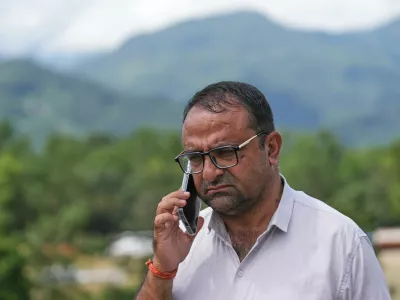 Rajendra Dawadi, a school teacher of Tribhuvan Trishuli Secondary School, talks on his mobile phone in Trishuli Valley in Nepal's Nuwakot district, Monday, Aug. 31, 2026. (AP Photo/Rajesh Kumar Singh)