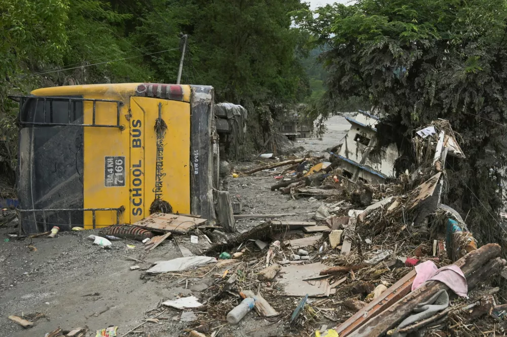A school bus near Trishuli River flipped and covered in mud, following deadly flash floods and a mudslide, in Betrawati Bazaar in Rasuwa district, Nepal, August 30, 2026. REUTERS/Stringer