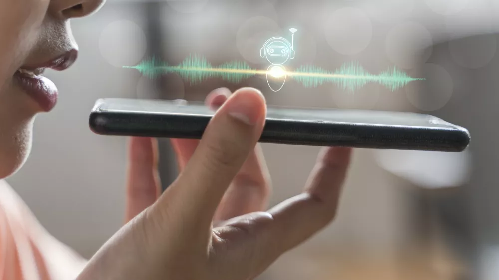 Close up of pretty woman holding in hand smart phone talking with digital assistant or friend distantly uses easy voice messaging, concept of modern ai technology, voice recognition, online translator