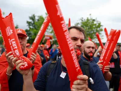 Employees of carmaker Volkswagen AG and IG Metall union members rally on the grounds of the Volkswagen headquarters on the day of the supervisory board meeting, in Wolfsburg, Germany, Thursday, July 9, 2026. (Lisi Niesner/Pool Photo via AP)