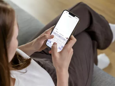 Poznan, Poland &ndash; April 14, 2025: A woman holding a smartphone and typing a question to the ChatGPT AI assistant, using a conversational text interface on the app,Image: 991604543, License: Royalty-free, Restrictions:, Model Release: no 