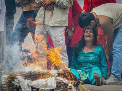 The wife of Bishi Pandey, who lost his life in the deadly flash floods and a mudslide, mourns during his cremation ritual using an effigy as his body remains missing, on the premises of Pashupatinath Temple in Kathmandu, Nepal, September 3, 2026. REUTERS/Adnan Abidi   TPX IMAGES OF THE DAY