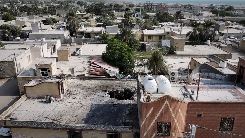 An aerial view shows the apparent point of impact on the roof of a building that Iranian media said was hit by a U.S. strike while a wedding celebration was taking place there, in Kuhestak, southern Iran, Wednesday, Sept. 2, 2026. (Morteza Akhoondi/Tasnim News Agency via AP)