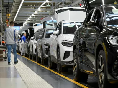 FILE PHOTO: Technicians work at the production line for electric car models of the Volkswagen Group in Zwickau, Germany, April 26, 2022. REUTERS/Matthias Rietschel/File Photo