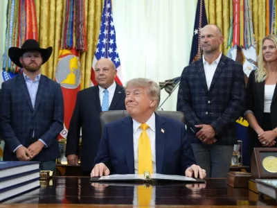 President Donald Trump speaks and announces action to help farmers and ranchers, as a group of farmers and ranchers stand behind, Friday, Sept. 4, 2026, in the Oval Office of the White House, in Washington. (AP Photo/Jacquelyn Martin)