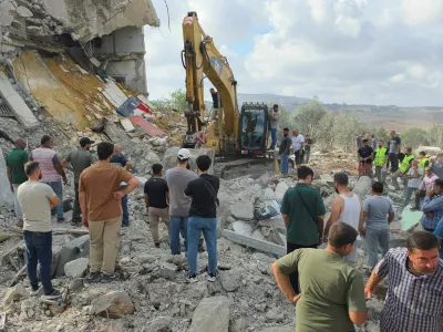 People stand amid rubble as heavy machinery operates at the site of an Israeli strike, in Arab Salim, Lebanon, September 6, 2026. Picture taken with a mobile phone. REUTERS/Ali Hankir