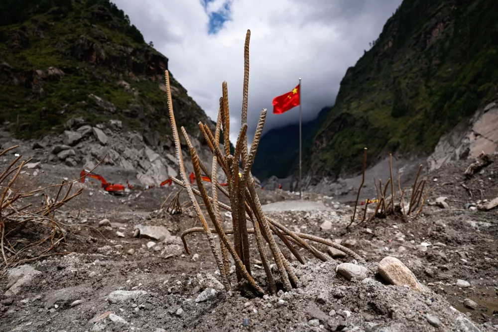 Steel bars that used to be part of the Gyirong Port buildings are exposed at the core disaster-hit area at Gyirong Port during an organised media tour in Shigatse, Tibet Autonomous Region, China, Sunday Sept. 6, 2026. (Tingshu Wang/Pool Photo via AP)