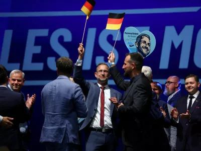Supporters of far-right Alternative for Germany (AfD) hold German flags after polls closed in the Saxony-Anhalt state elections, in Magdeburg, Germany, September 6, 2026. REUTERS/Thilo Schmuelgen