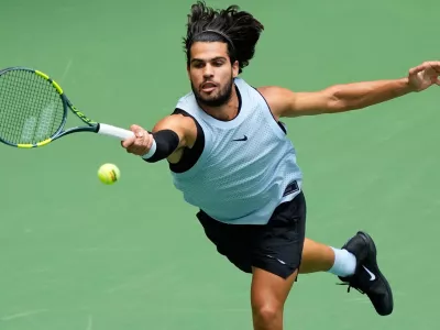 Carlos Alcaraz, of Spain, returns the ball to Tommy Paul, of the United States, during the fourth round of the U.S. Open tennis championships Sunday, Sept. 6, 2026, in New York. (AP Photo/Yuki Iwamura)