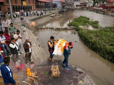 Relatives carry an effigy of a loved one missing in the recent flash floods during a symbolic funeral on the banks of the Bagmati River in Kathmandu, Nepal, Monday, Sept. 7, 2026. (AP Photo/Dar Yasin)