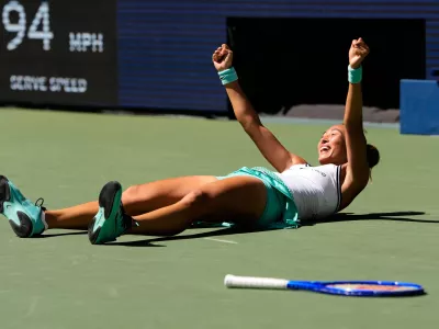 Qinwen Zheng, of China, celebrates after winning a match against Iga Swiatek, of Poland, during the fourth round of the U.S. Open tennis championships, Monday, Sept. 7, 2026, in New York. (AP Photo/Seth Wenig)