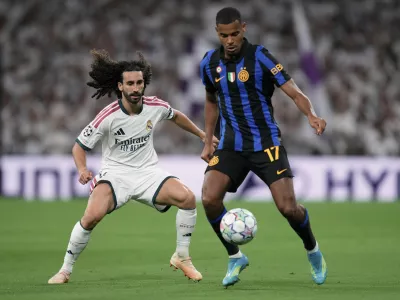 Real Madrid's Marc Cucurella fights for the ball against Inter Milan's Andy Diouf during a Champions League soccer match between Real Madrid and Inter Milan in Madrid, Spain, Tuesday, Sept. 8, 2026. (AP Photo/Bernat Armangue)