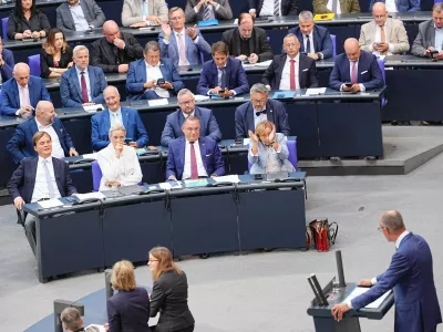 Federal chairwoman and parliamentary group leader of the AfD Alice Weidel, sitting in first row, centre left, looks at German Chancellor Friedrich Merz as he speaks during the general debate as part of the budget deliberations in the Bundestag, in Berlin, Wednesday Sept. 9, 2026. (Michael Kappeler/dpa via AP)