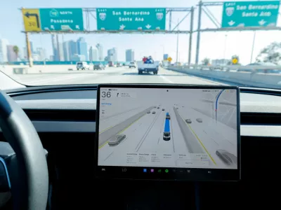 FILE PHOTO: A 2025 Tesla Model 3 self-drives with FSD 14.1.4 software on a freeway in Los Angeles, California, U.S., November 6, 2025. REUTERS/Mike Blake/File Photo