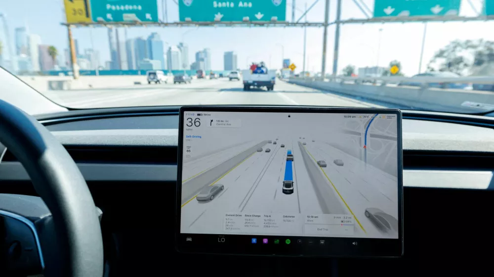 FILE PHOTO: A 2025 Tesla Model 3 self-drives with FSD 14.1.4 software on a freeway in Los Angeles, California, U.S., November 6, 2025. REUTERS/Mike Blake/File Photo