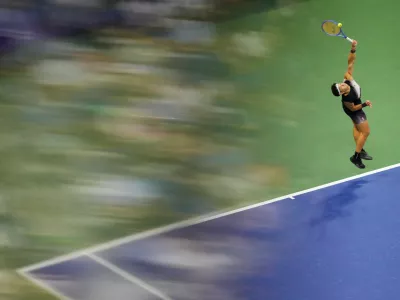 Ben Shelton, of the United States, serves the ball to Frances Tiafoe, of the United States, during the men's singles semifinals of the U.S. Open tennis championships Friday, Sept. 11, 2026, in New York. (AP Photo/Yuki Iwamura)