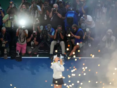 Elena Rybakina, of Kazakhstan, kisses the trophy after she won the women's singles final of the U.S. Open tennis championships against Aryna Sabalenka, of Belarus, Saturday, Sept. 12, 2026, in New York. (AP Photo/Yuki Iwamura)