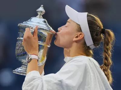 Elena Rybakina, of Kazakhstan, kisses the trophy after she won the women's singles final of the U.S. Open tennis championships against Aryna Sabalenka, of Belarus, Saturday, Sept. 12, 2026, in New York. (AP Photo/Kirsty Wigglesworth)