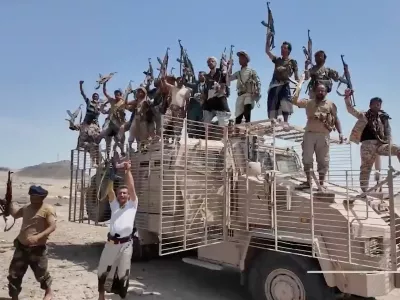 This image taken from undated video released by the Houthi-run Al-Masirah television channel on Saturday, Sept. 12, 2026, shows Houthi fighters chanting and raising rifles atop a military vehicle in Dhubab district, Taiz province, Yemen, according to the channel. (Al-Masirah TV via AP)