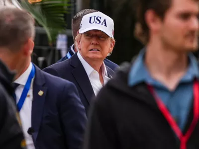 U.S. President Donald Trump, center, attends the Irish Open golf tournament at Trump International Golf Links in Doonbeg, Ireland, Sunday, Sept. 13, 2026. (AP Photo/Julia Demaree Nikhinson)