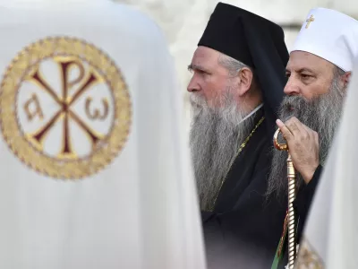 Head of the Serbian Orthodox Church, Patriarch Porfirije, right, and Mitropolitan Joanikije at the arrival ceremony in front of the Serbian Orthodox Church of Christ's Resurrection in Podgorica, Montenegro, Saturday, Sept. 4, 2021. Serbian patriarch Porfirije arrives at Podgorica ahead of the inauguration of the new bishop of the Serbian Orthodox Church in Montenegro scheduled in Cetinje, sparking tensions. On Saturday, hundreds of protesters confronted the police in Cetinje and briefly removed some of the protective metal fences around the monastery where the inauguration of Mitropolitan Joanikije is supposed to take place. (AP Photo/Risto Bozovic)