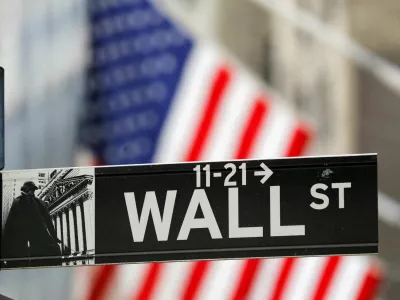 FILE PHOTO: A street sign for Wall Street is seen outside the New York Stock Exchange (NYSE) in New York City, New York, U.S., July 19, 2021. REUTERS/Andrew Kelly/File Photo