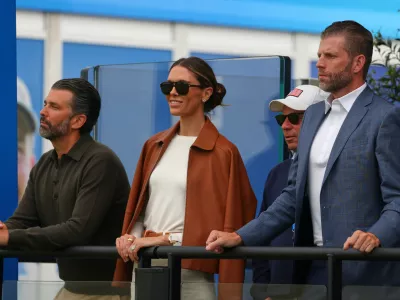 U.S. President Donald Trump's sons Eric Trump, right, Donald Trump Jr, and his wife Bettina watch the play at the Irish Open at the Trump International Golf Links course in Doonbeg, Ireland, Sunday, Sept. 13, 2026.(AP Photo/Peter Morrison)