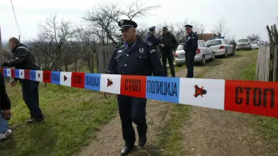 A policeman stands guard in the village of Velika Ivanca, about 40 km (25 miles) southwest of Belgrade April 9, 2013. A gunman shot dead 13 people, including his mother and son, in an early-morning rampage through a small Serbian village southwest of the capital Belgrade on Tuesday, authorities said. Those killed included a two-year-old child. The gunman, identified by police as Ljubisa Bogdanovic - a war veteran born in 1953 - also shot his wife before turning the gun on himself. Both were in critical condition in hospital, police said.  REUTERS/Marko Djurica (SERBIA - Tags: CRIME LAW)