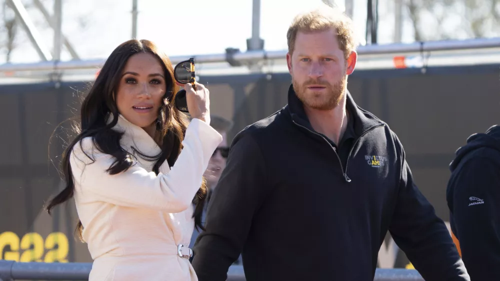 Prince Harry and Meghan Markle, Duke and Duchess of Sussex visit the track and field event at the Invictus Games in The Hague, Netherlands, Sunday, April 17, 2022. The week-long games for active servicemen and veterans who are ill, injured or wounded opened Saturday in this Dutch city that calls itself the global center of peace and justice. (AP Photo/Peter Dejong)
