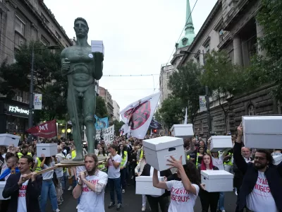 Political candidates, students and citizens carry signatures for the "Student list - Students win" to the Republic Election Commission towards participation in the upcoming parliamentary elections in Belgrade, Serbia, Monday, Sept. 14, 2026. (AP Photo/Darko Vojinovic)