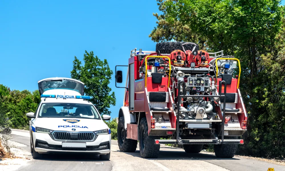 Labin,Croatia, 2023: Police car (Policija) and fire truck (vatrogasci) on a country road near Labin