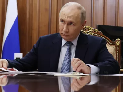 Russian President Vladimir Putin listens to the Head of the Russian Federal Service for the Oversight of Consumer Protection and Welfare (Rospotrebnadzor) Anna Popova at the Kremlin in Moscow, Tuesday, Sept. 15, 2026. (Vyacheslav Prokofyev/Sputnik, Kremlin Pool Photo via AP)