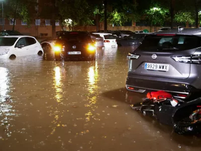 Partially submerged vehicles stand surrounded by flood water while it rains, after local authorities issued a weather alert in Valencia, Spain, September 17, 2026, REUTERS/Eva Manez