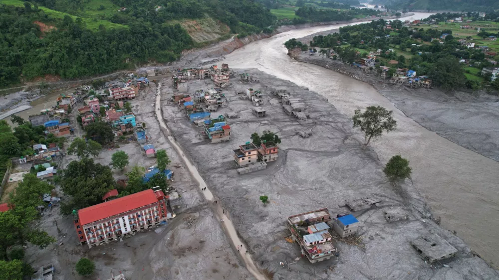 FILE - Homes are engulfed in mud in the aftermath of flash flooding along the Trishuli River in the Devighat area of Nuwakot district, Nepal, Aug. 29, 2026. (AP Photo/Rajesh Kumar Singh, File)