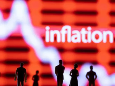 FILE PHOTO: Figurines are seen in front of displayed stock graph and word "Inflation" in this illustration taken June 13, 2022. REUTERS/Dado Ruvic/Illustration/File Photo