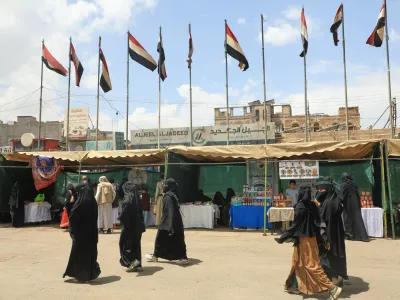 People walk past Yemeni flags in Sanaa, Yemen, Thursday, Sept. 17, 2026. (AP Photo/Osamah Abdulrahman)