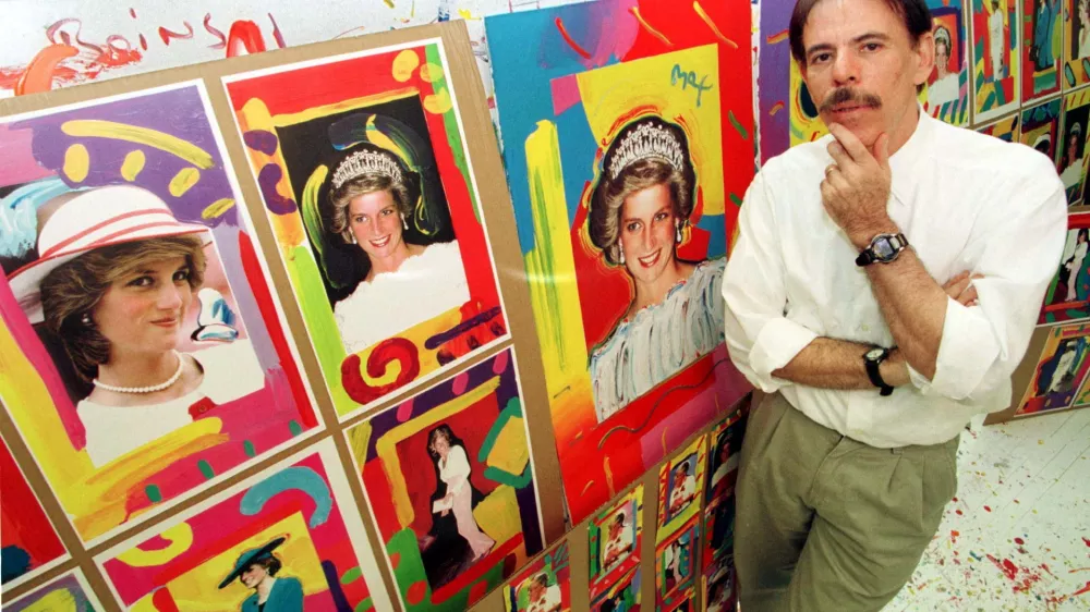 FILE PHOTO: Artist Peter Max poses near pictures of Diana, Princess of Wales, in his New York studio, U.S., August 25, 1998. REUTERS/Peter Morgan/File Photo