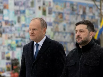 FILE PHOTO: Ukraine's President Volodymyr Zelenskiy and Polish Prime Minister Donald Tusk visit the Wall of Remembrance of the Fallen for Ukraine outside the Saint Michael's Cathedral, amid Russia's attack on Ukraine, in Kyiv, Ukraine February 5, 2026. Ukrainian Presidential Press Service/Handout via REUTERS ATTENTION EDITORS - THIS IMAGE HAS BEEN SUPPLIED BY A THIRD PARTY/File Photo/File Photo