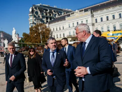 From left: Slovenian Minister of Defence Valentin Hajdinjak, Slovenian Foreign Minister Tone Kajzer and Ukrainian Foreign Minister Andrii Sybiha walk at Saint Michael's Square in Kyiv, Ukraine, on Thursday, September 17, 2026. (AP Photo/Evgeniy Maloletka)