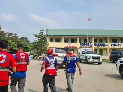 In this handout photo provided by the Philippine Red Cross, Red Cross members arrive at Banga National High School in the town of Banga, Philippines, Friday, Sept. 18, 2026. (Philippine Red Cross via AP)