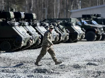 FILE PHOTO: A member of the military walks at the US army base at Grafenwoehr, Germany March 11, 2022. REUTERS/Andreas Gebert/File Photo