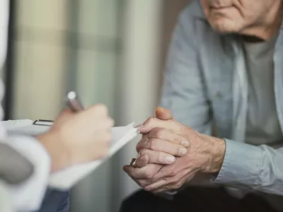 Doctor talks with patient and takes notes