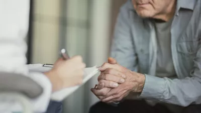 Doctor talks with patient and takes notes