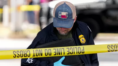 An Immigration and Customs Enforcement officer walks the scene where a man was shot in his vehicle by an ICE officer, Sunday, Sept. 20, 2026, in Austin, Texas. (Aaron E. Martinez /Austin American-Statesman via AP)