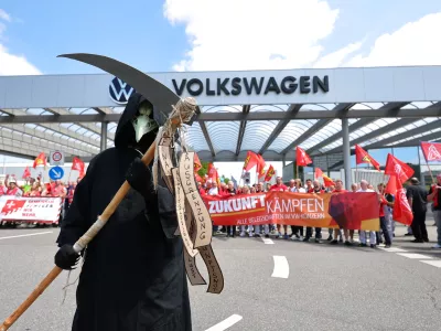 Workers stage a protest in front of the Volkswagen plant in Zwickau, Germany, Thursday, July 9, 2026. (Jan Woitas/dpa via AP)
