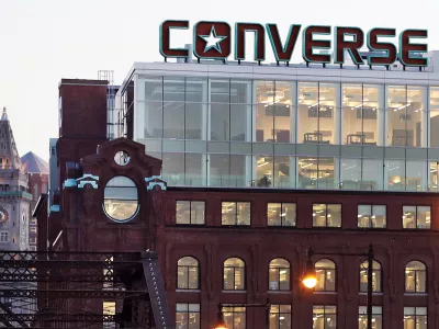 FILE - The Converse logo is displayed on the roof of the company's world headquarters in the West End neighborhood of Boston, Wednesday, Dec. 28, 2016. (AP Photo/Charles Krupa, file)