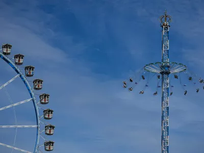 People ride a swing besides a ferris wheel at the 191st Oktoberfest beer festival in Munich, Germany, Sunday, Sept. 20, 2026. (AP Photo/Matthias Schrader)