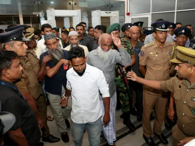 Men convicted over the 2019 Easter bombings that killed 279 people are escorted by police officers in Colombo, Sri Lanka, September 23, 2026. REUTERS/Lahiru Harshana