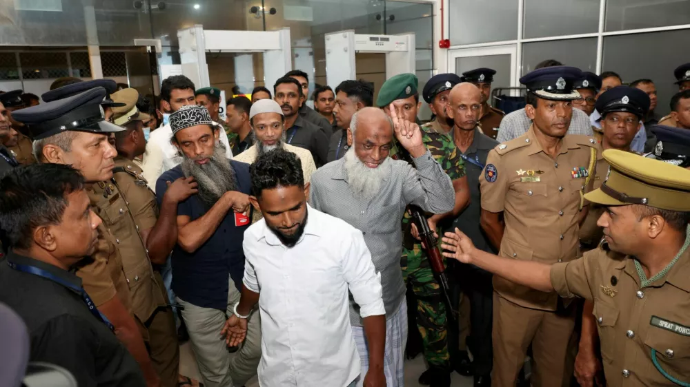 Men convicted over the 2019 Easter bombings that killed 279 people are escorted by police officers in Colombo, Sri Lanka, September 23, 2026. REUTERS/Lahiru Harshana